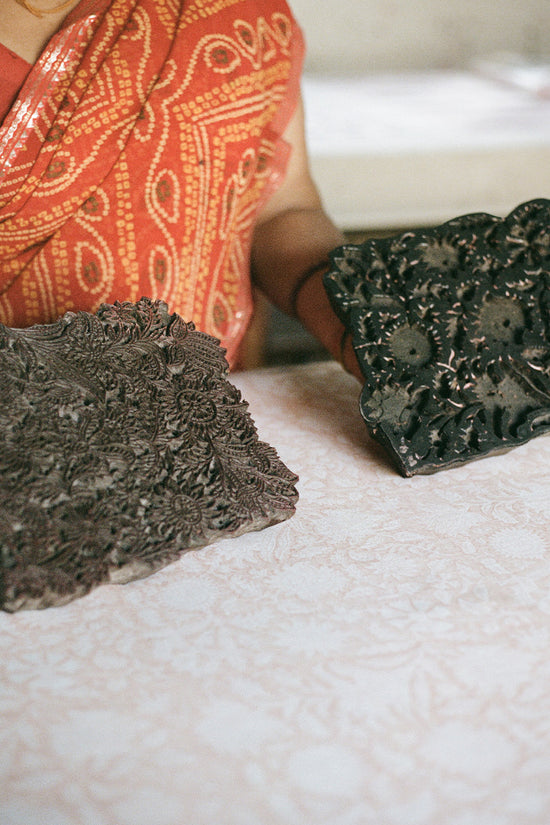 Daughters of India — Jaipur artisan hand block printing floral pattern with carved wooden blocks onto cotton fabric