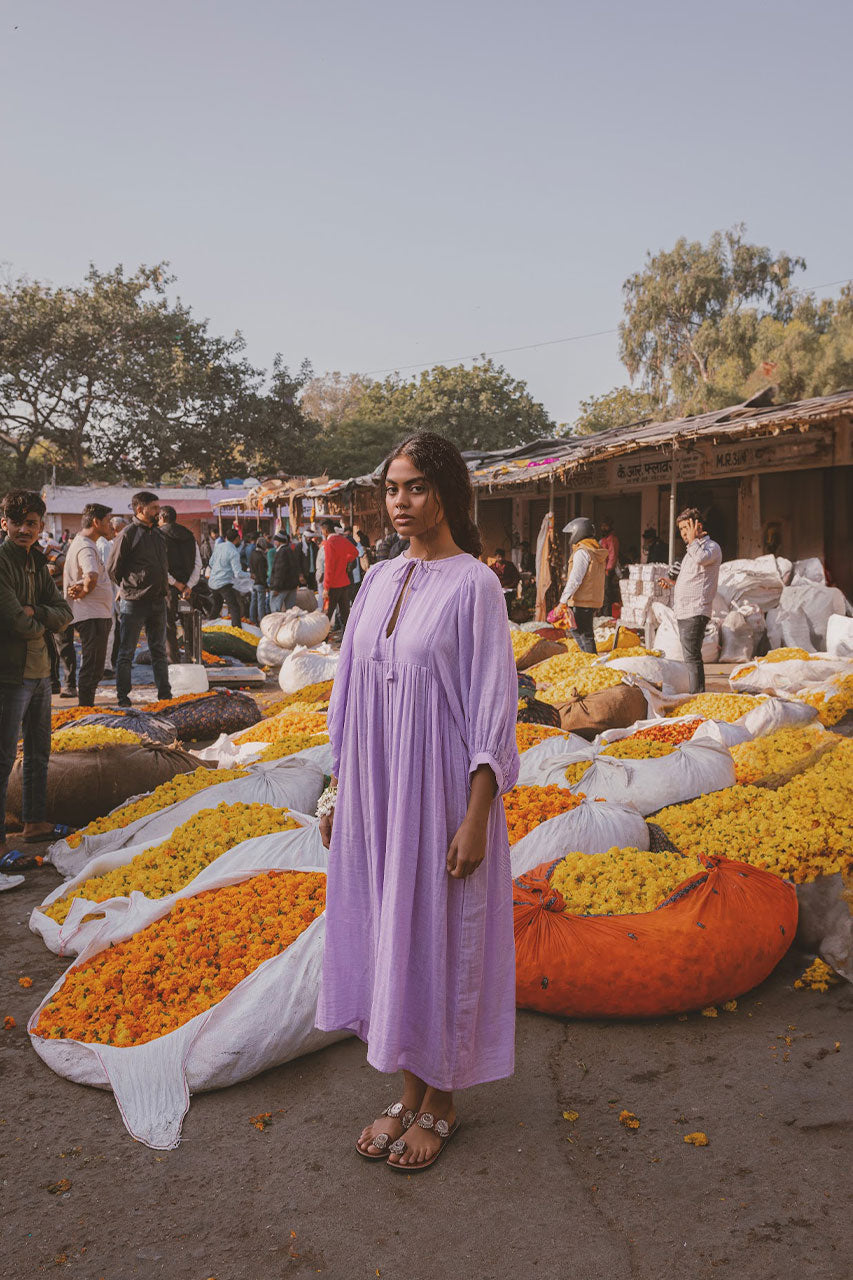 Daughters of India Kyra Midi Dress in Lilac Gauze — full length at Indian flower market with marigolds, cotton gauze
