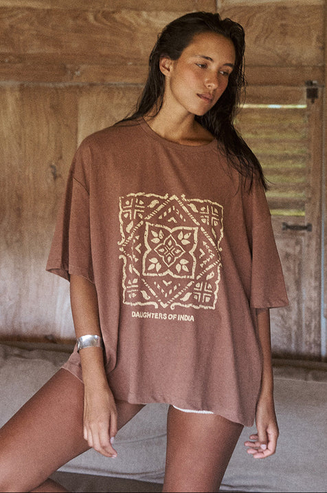 Woman wearing the Daughters of India Shanti Tee in Hazel, an oversized brown linen-cotton blend t-shirt with block print graphic design
