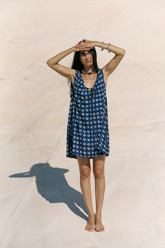 Sundress Mini Indigo — full body front view on white sand, hand block print daisy indigo mini | Daughters of India